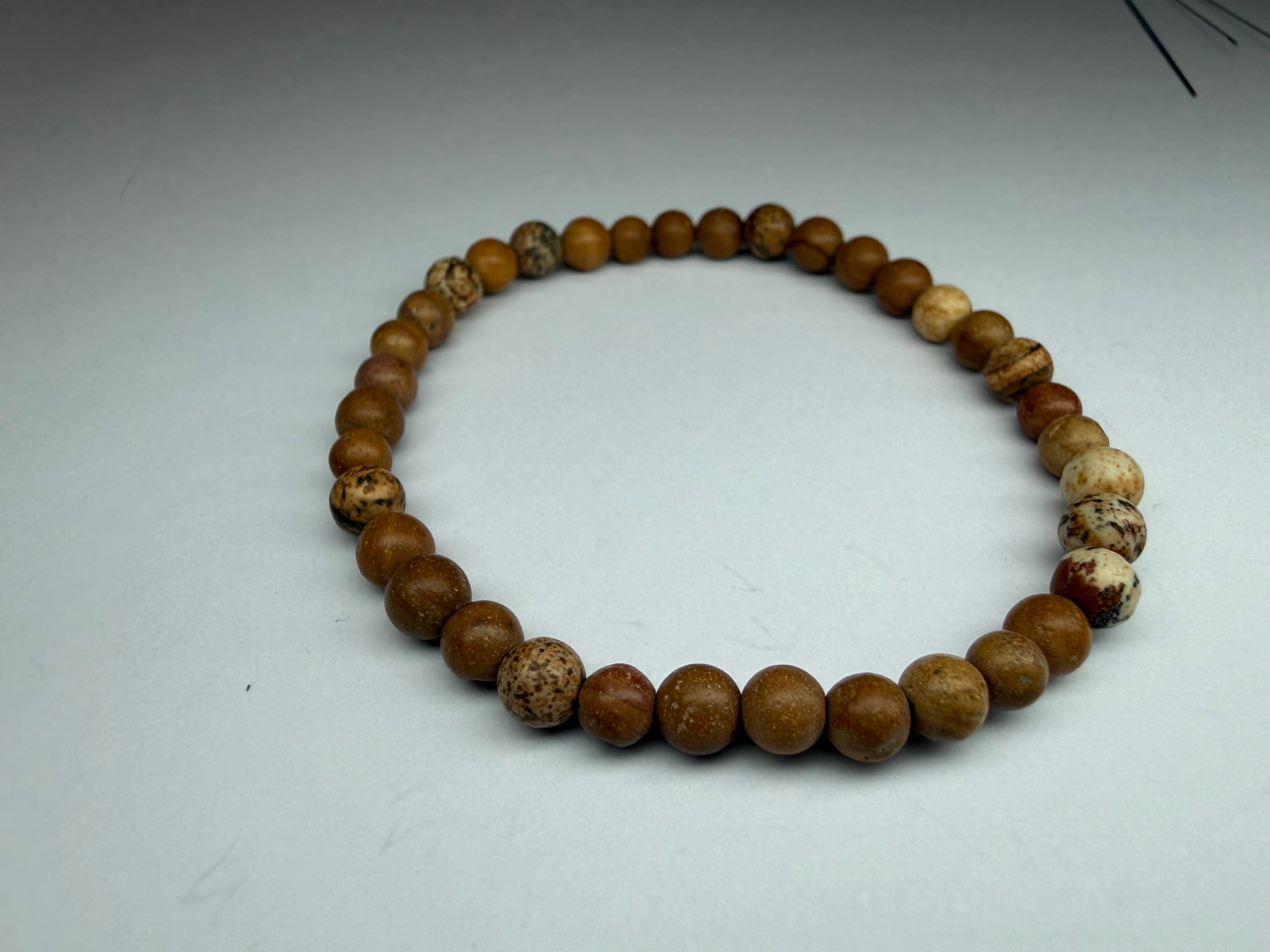 Beaded necklace with brown and beige beads on a white background