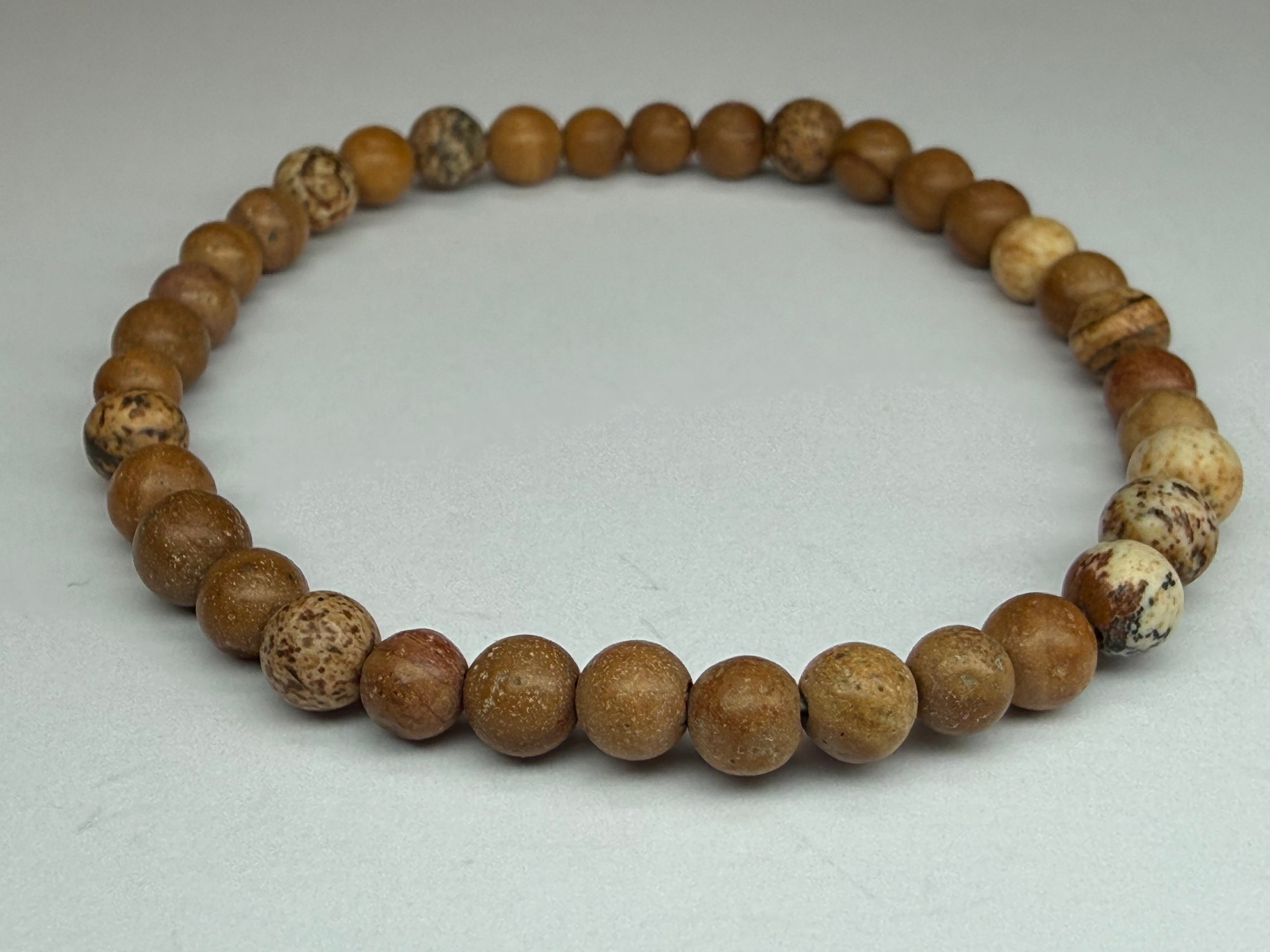 Bracelet made of brown beads on a light gray background