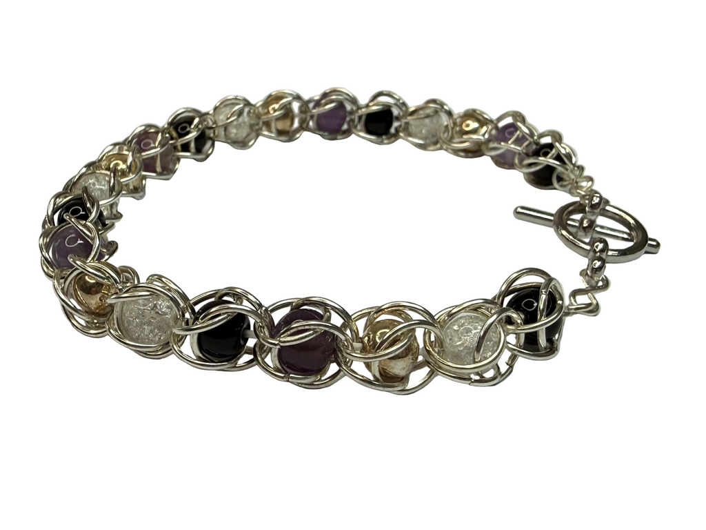 Silver bracelet with interlocking rings on a white background