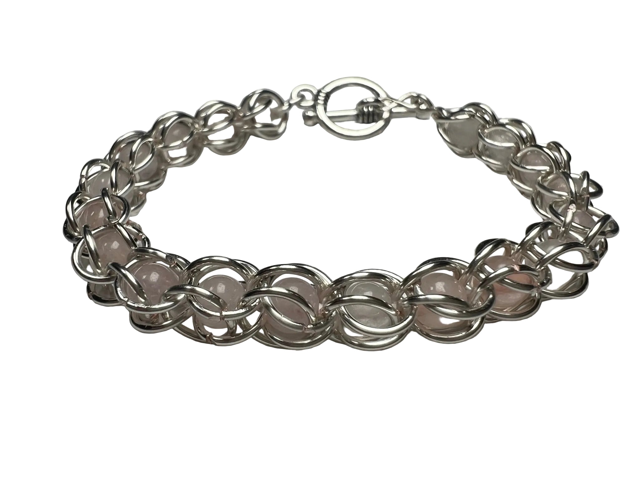 Silver chain bracelet on a light gray background